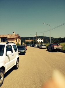 The yellow house on the left is ours - surrounded by cars.